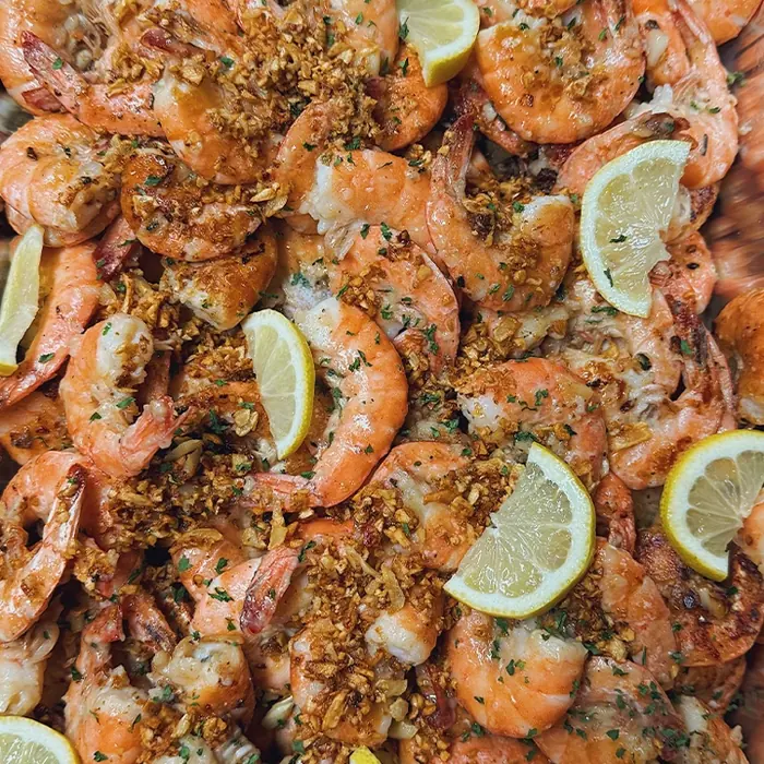 Tray of garlic shrimp with lemon